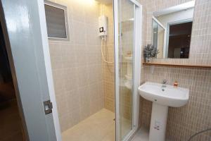 a bathroom with a sink and a glass shower at Maruay Living Apartment 509 (Khaosan/Chinatown/Samyot MRT) in Bangkok +7 photos