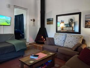 a living room with a couch and a fire place at 18 on Mark in Willowmore