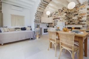 a kitchen and living room with a table and chairs at Zos Suites in Kanakis