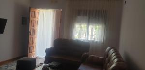 a living room with a couch and a window at Hills Villa in Vlorë
