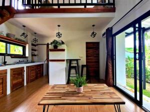 a kitchen with a table in the middle of a room at S&S House in Srithanu