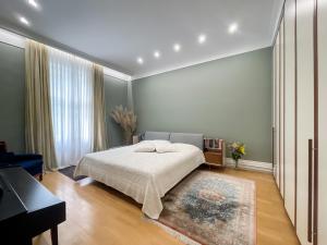 a bedroom with a bed and a piano at 3 Bedroom apartment Zagreb center in Zagreb