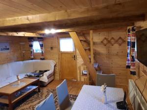 a living room with a couch and a table at Holiday house Radić in Sošice