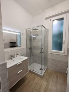 a bathroom with a shower and a sink at Elisir Home in Genova