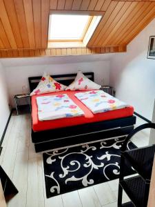 1 dormitorio con 1 cama con ventana y alfombra en Haus Heidrun, en Dolgesheim
