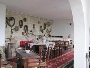 a dining room with tables and chairs and a stone wall at Casa vacanze nel cuore della sicilia in Santa Caterina Villarmosa