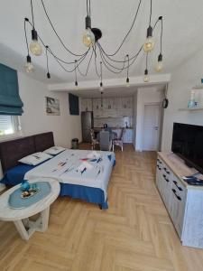 a bedroom with a bed and a table in it at Studio apartman Happy Home in Tivat