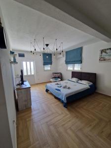 a large bedroom with a bed and a wooden floor at Studio apartman Happy Home in Tivat