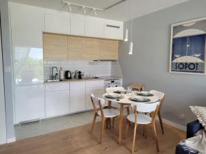 a kitchen and dining room with a table and chairs at Baltika in Gdańsk