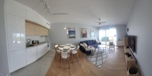 a kitchen and living room with a couch and a table at Baltika in Gdańsk