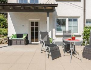 a patio with a table and chairs on a patio at Haus Salweyblick in Niedersalwey