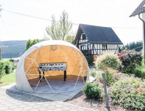 a large dome tent in front of a house at Haus Salweyblick in Niedersalwey +10 photos
