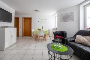 a living room with a couch and a table at Haus Salweyblick in Niedersalwey