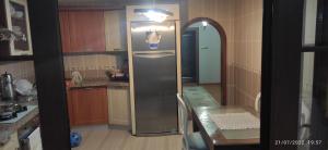 a kitchen with a stainless steel refrigerator in it at Dağ ve Denizi Bir arada yaşatan tatil evi in Akcaabat