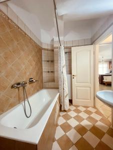 a bathroom with a bath tub and a sink at Marina's House in Parga