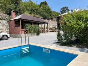 a swimming pool in a yard with a building at Green Garden in Ijevan