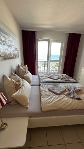 a bedroom with a bed with a view of the ocean at Apartment "OCEANVIEW" in Lubmin