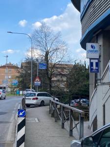 a street with cars parked next to a building at Casa Valentina 1 in Perugia