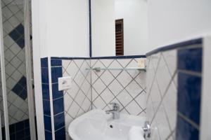 a bathroom with a sink and a mirror at Casa Lussu in Lipari