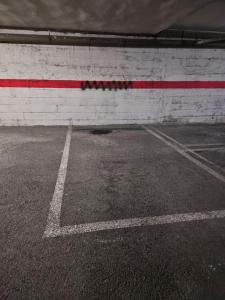 an empty parking lot with a red and white wall at 633A Colloto, 3 dorm. y garaje in Santa Eulalia
