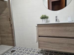 a bathroom with a sink and a mirror at 633A Colloto, 3 dorm. y garaje in Santa Eulalia