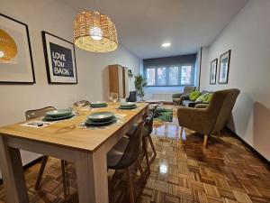 a dining room with a table and chairs and a living room at 633A Colloto, 3 dorm. y garaje in Santa Eulalia