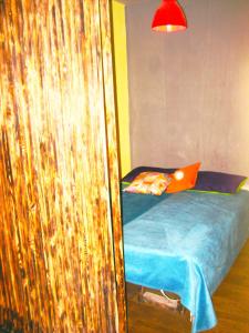 a bedroom with a bed with an orange laptop on it at City Center Suit in Yerevan
