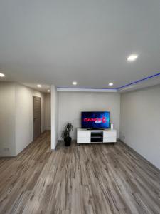 an empty living room with a flat screen tv at A place to take a rest. in Tukums