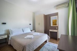 a bedroom with a bed with two towels on it at Villa Marija in Trogir