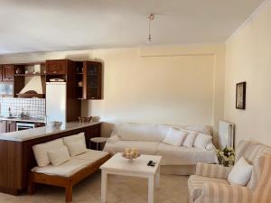 a living room with a couch and a table at Marina's House in Parga