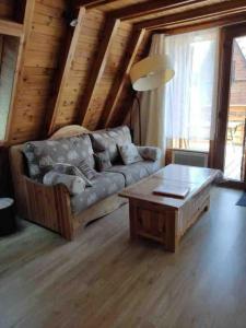 a living room with a couch and a coffee table at Chalet 8 à 10 couchages in Le Dévoluy