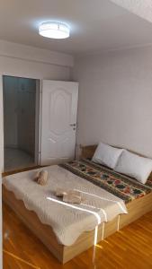 a bedroom with a large bed with a white door at Villa Koteski - Spacious Apt, Near Lake & Parking in Ohrid