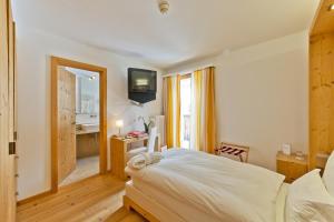 Postel nebo postele na pokoji v ubytování Hotel Müller - mountain lodge
