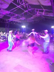a group of people dancing on a dance floor at Rania Chalet -Stella Di Mare Sea view- Families in Ain Sokhna