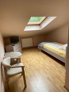 a small bedroom with a bed and a skylight at Tedi 2 in Rewal