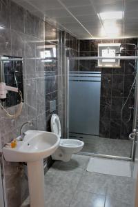 a bathroom with a sink and a toilet and a shower at KUZEY OTEL in Sinop