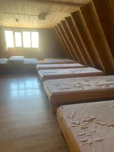 a row of mattresses are lined up in a room at Gíslaskáli in Bergsstaðir