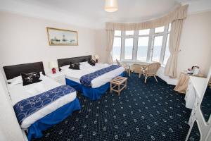 a hotel room with two beds and a window at The Seacourt in Bridlington