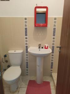 a bathroom with a toilet and a sink and a mirror at complexe doha marjane tetouan in Tétouan
