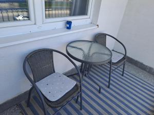 2 stoelen en een tafel op een balkon bij Enjoy traveling in Tuzla
