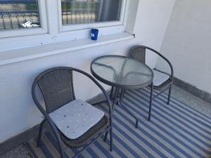 two chairs and a table on a balcony at Enjoy traveling in Tuzla