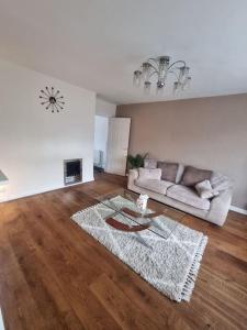 a living room with a couch and a table at Somers Lodge in Leicester