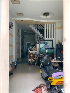 a hallway with a motorcycle parked in a room at Sky Happy in Ho Chi Minh City