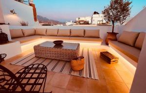 a living room with a couch and a table at Hostal Boutique Plaza Cantarero in Nerja