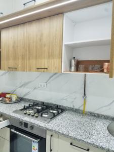 a kitchen with a stove and a counter top at Joli Villa à Sahloul in Sousse