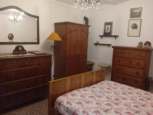 a bedroom with a bed and a dresser and a mirror at B&B BORGORI' in Rivola
