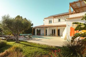 a villa with a swimming pool and a house at Birds of Paradise in Aljezur