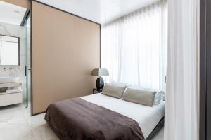 Posteľ alebo postele v izbe v ubytovaní NJ Hotels & Apartments San Pietro all'orto 6