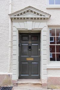 a black door in a white building at Ludlow Townhouse in Ludlow