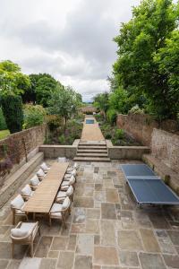 a patio with chairs and tables and a pathway at Ludlow Townhouse in Ludlow